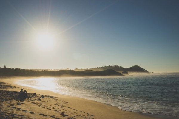 A beach with sand and water on it