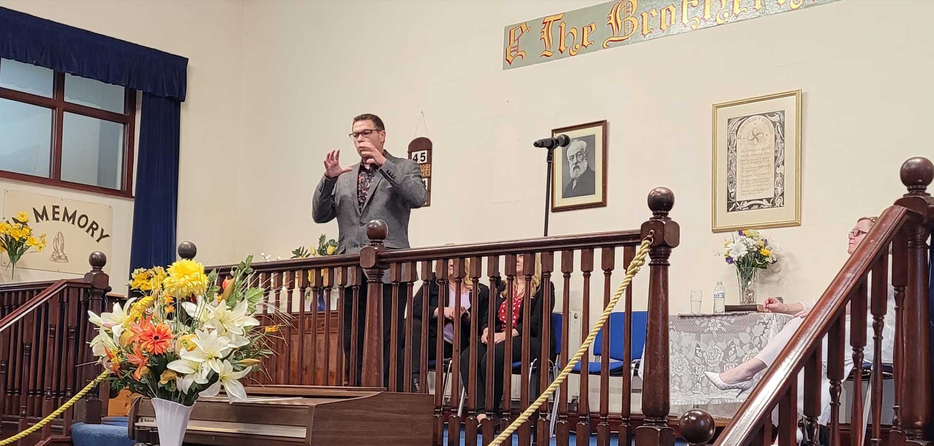 A man standing on top of a wooden railing.